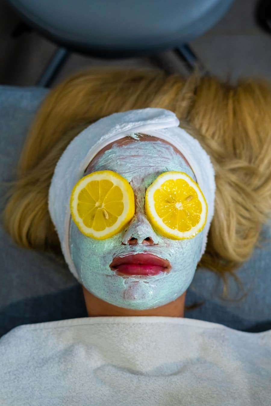 A person with a towel wrapped around their head during a facial